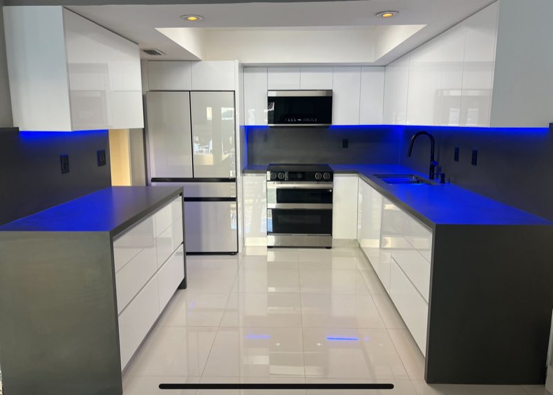 Sleek white kitchen with under-cabinet accent lighting