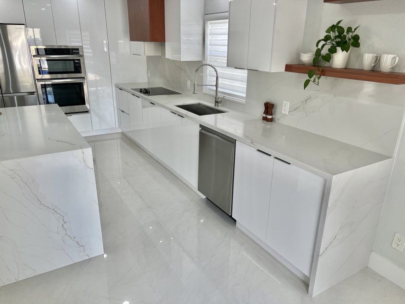 White kitchen with marble backsplash and floating shelves